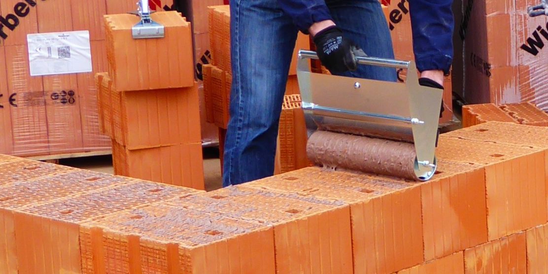 Installation of Porotherm BIO PLAN: man with roller and Mason