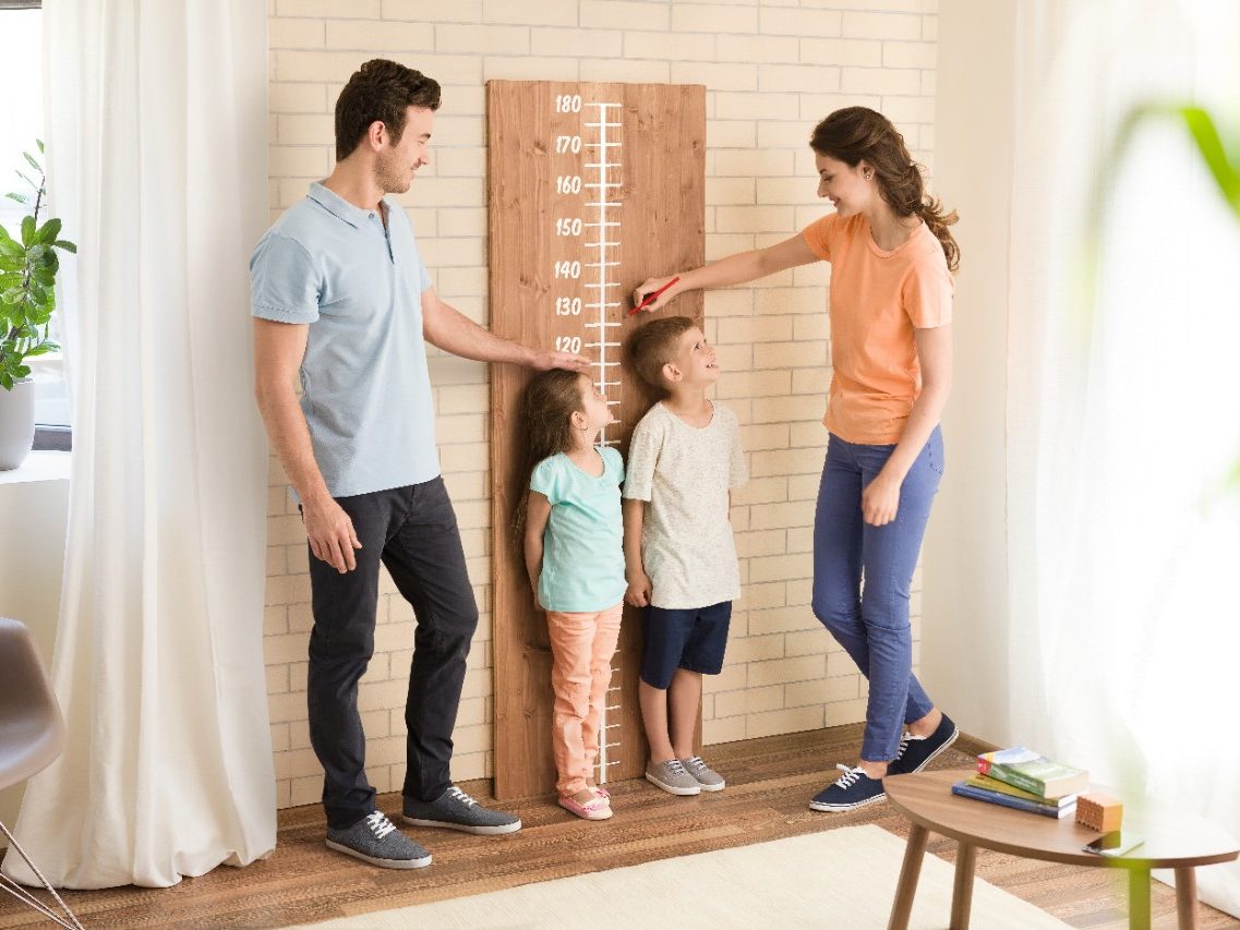 Parents measuring children's height