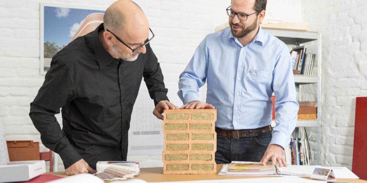 Architect and Wienerberger project manager talking about advantages of a mineral wool infilled clay block at architect's office