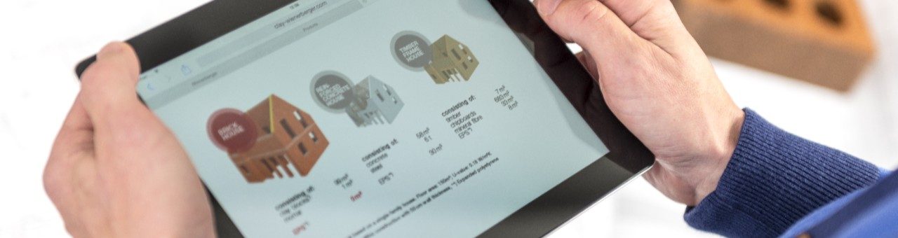 Hands holding tablet showing a comparison of building types