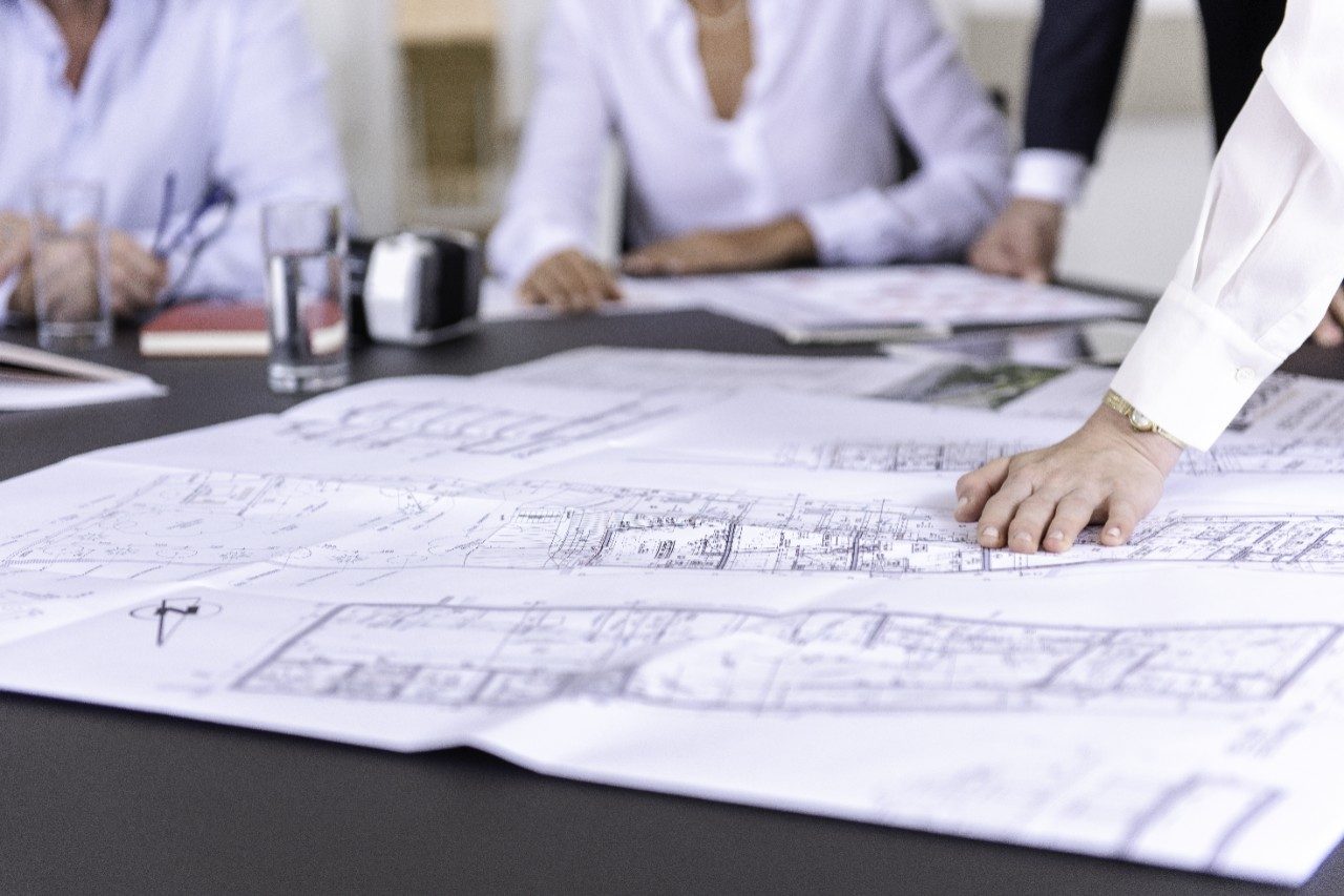 Blueprints at conference table