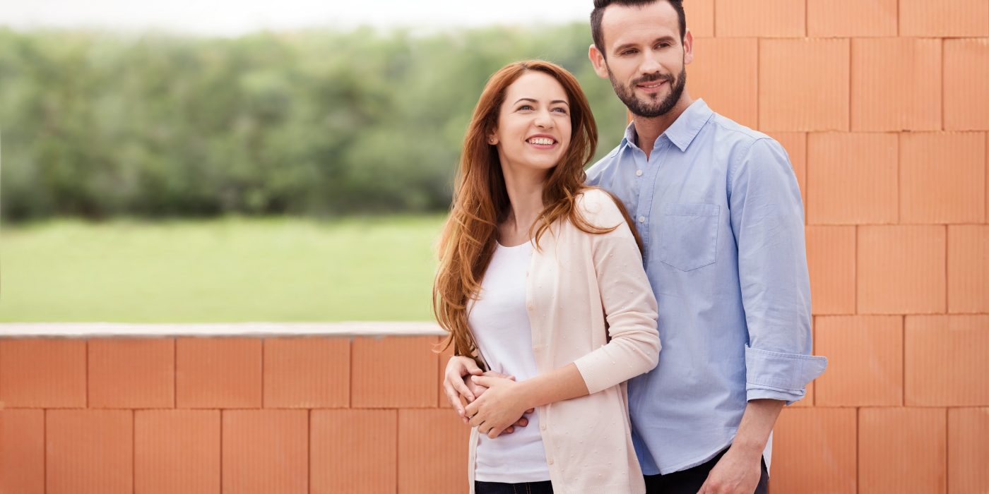 Couple inside their future home inside building shell
