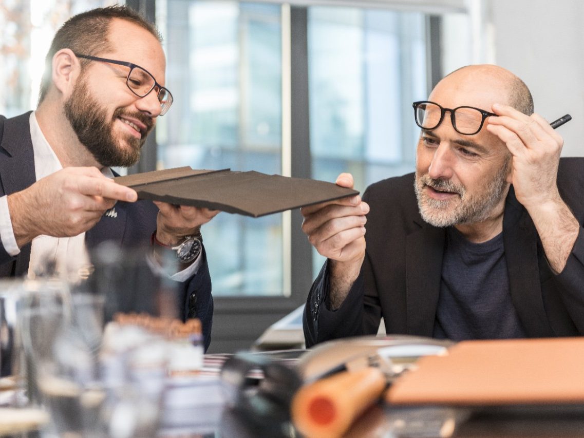 Architect inspecting clay roof or facade tile (Bellus, Facatile) at a meeting room with Wienerberger employee, Fast Forward Commercial Excellence