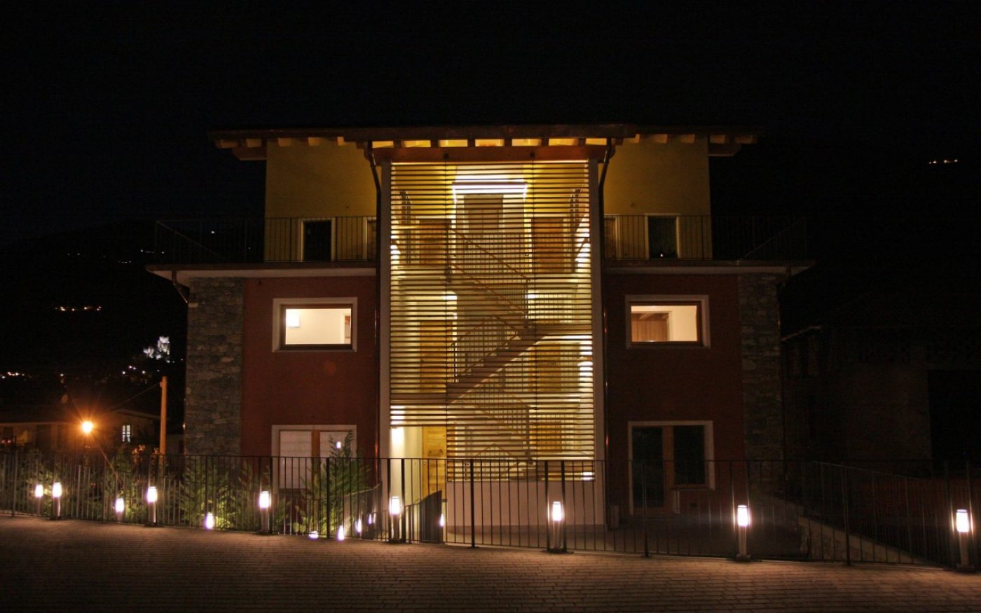 Overview of multi family house in the night Aosta renovation with Porotherm