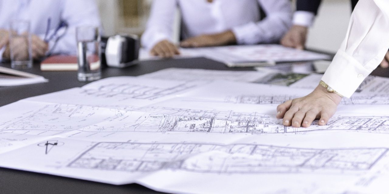 Blueprints at conference table