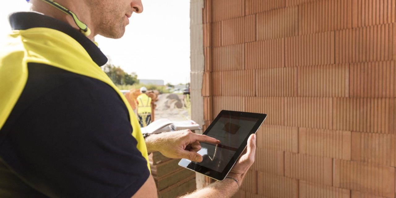 Construction worker with tablet computer