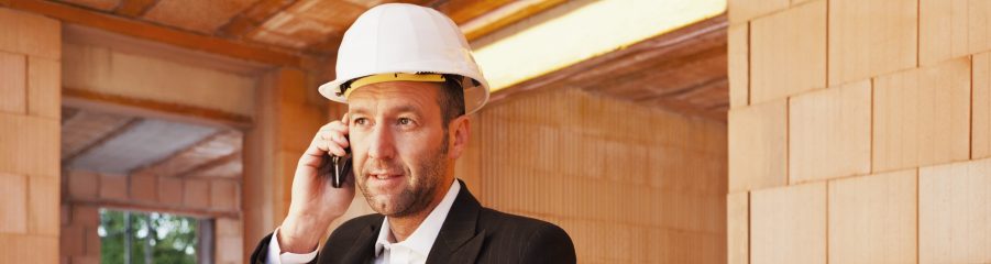 Building professional with mobile phone and blueprint inside building-shell